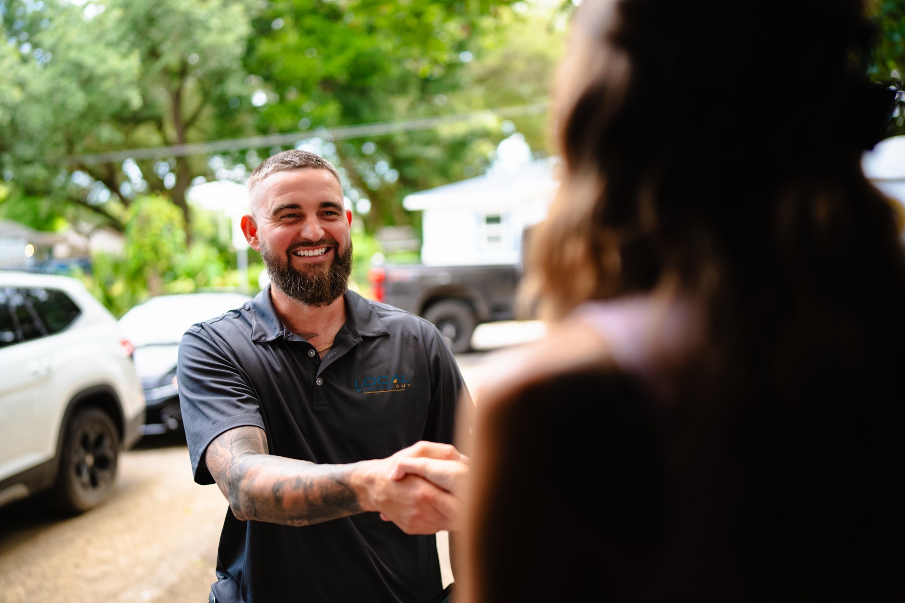 Local Window Guy owner greeting a Pensacola homeowner with a handshake