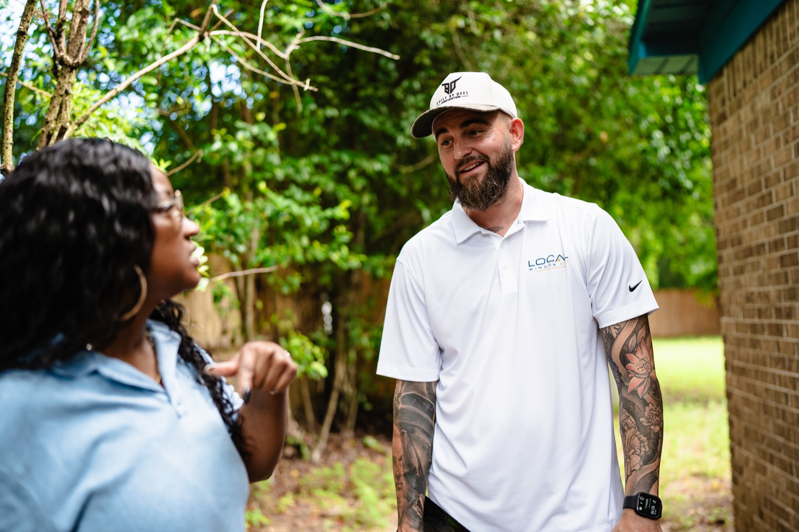 Local Window Guy owner talking with a Pensacola homeowner about her windows